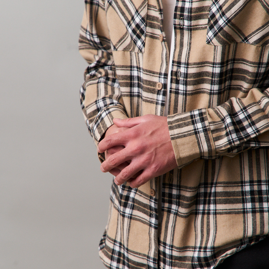 close up of long sleeve beige flannel shirt
